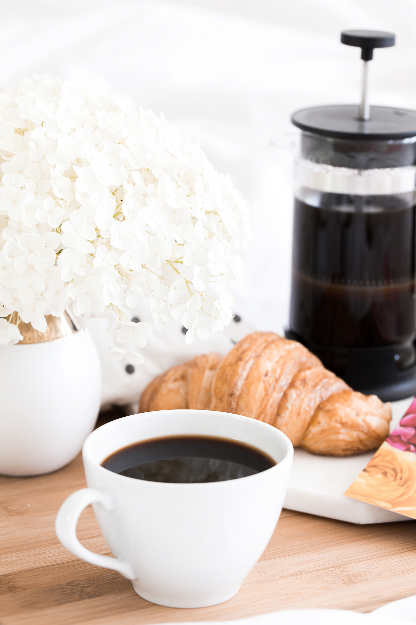 A coffee maker and cup of coffee