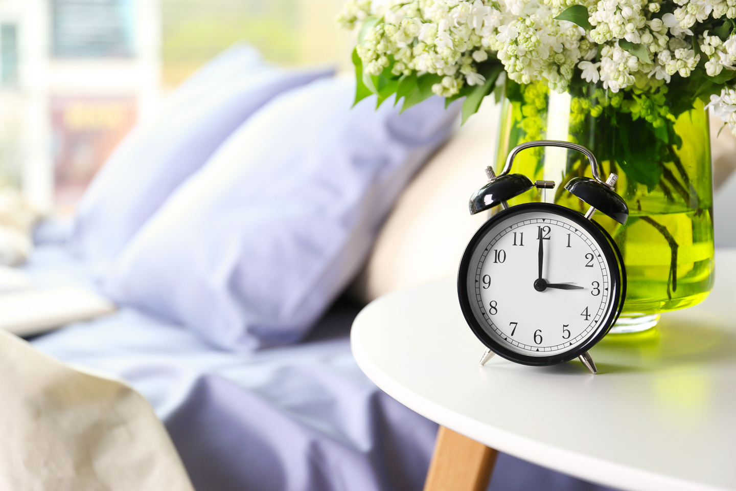 An alarm clock on a bedside table