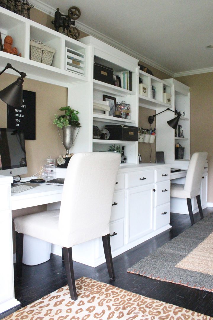 Home office design with two desks in built-in bookshelves