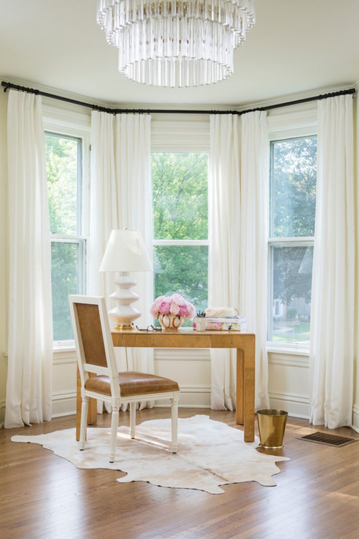 Small desk and chair in a bow window