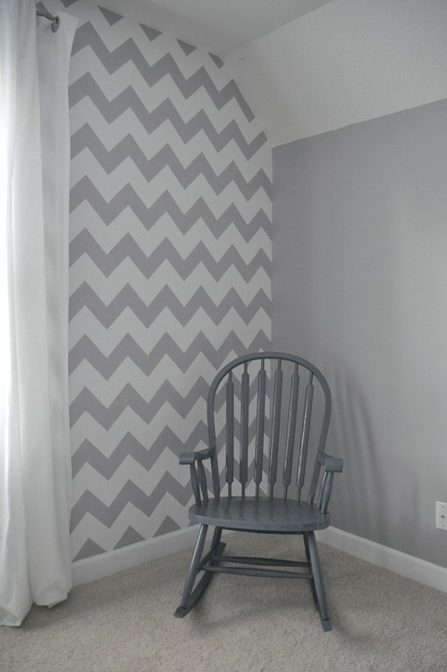 Wall painted with grey and white chevon stripes