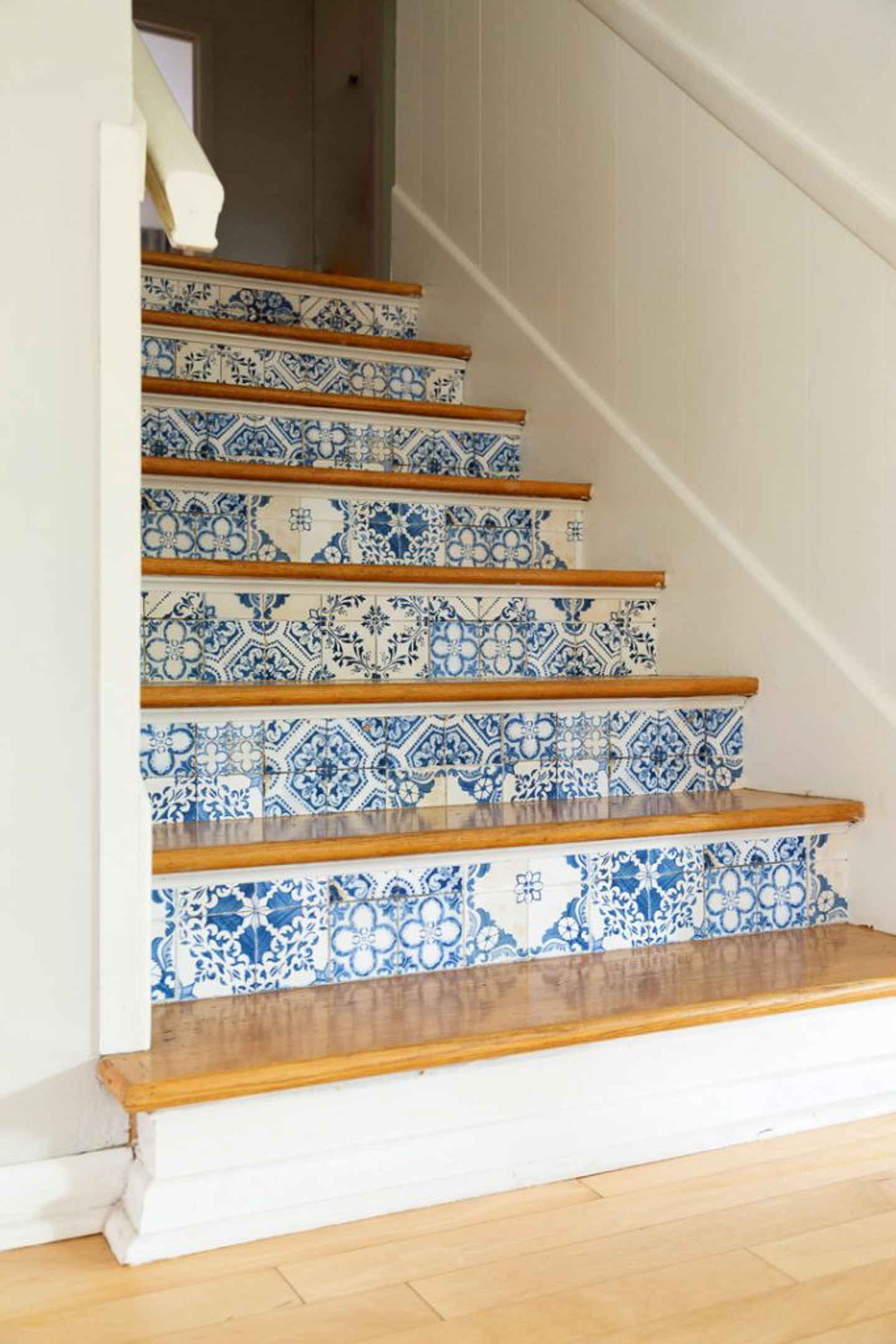 Stair risers wallpapered with a tile pattern via aliceandlois.com