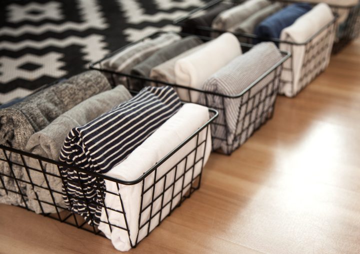 Wire baskets with folded clothes in them