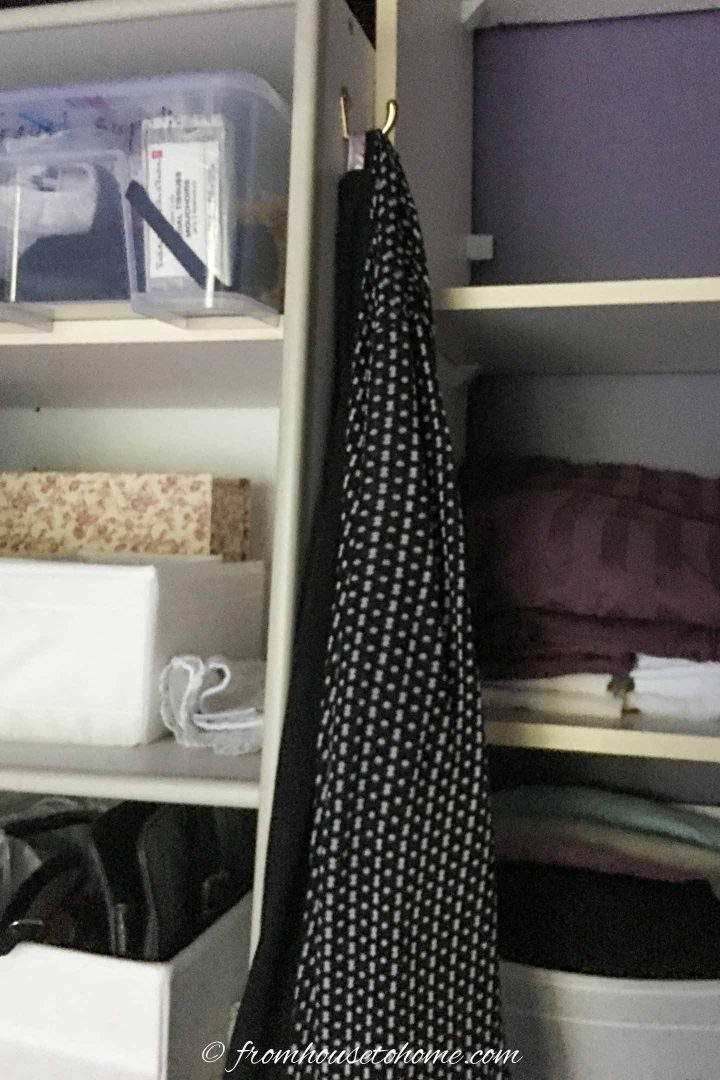 A hook installed in a closet with a housecoat hung on it