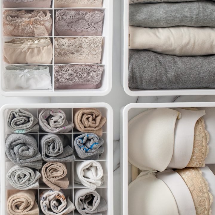 Clothing folded or rolled and stored vertically in bins