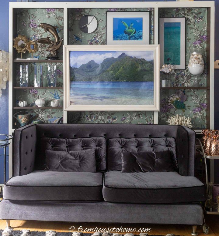 Gray sofa in front of living room bookshelves