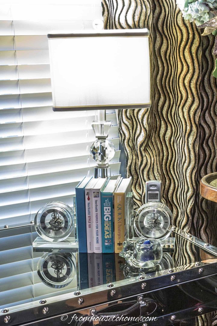 a shiny lamp base with a white shade on a desk, perfect to brighten a dark room.
