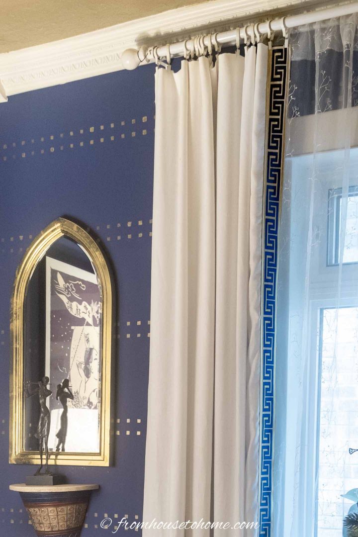 Greek key trim on white living room curtains