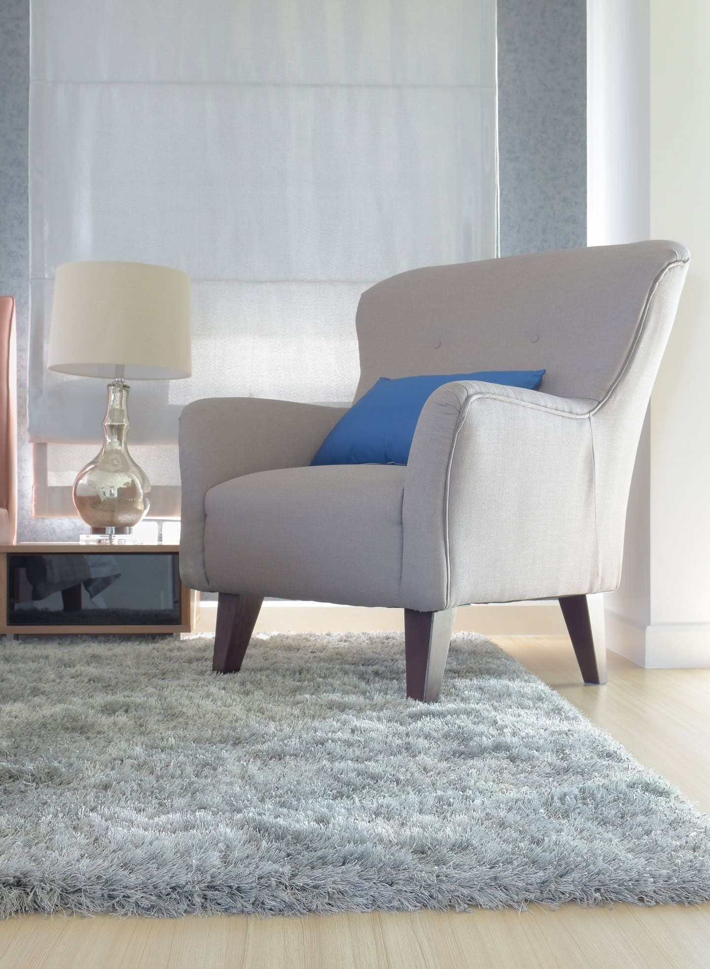 Upholstered chair with a cozy area rug under it