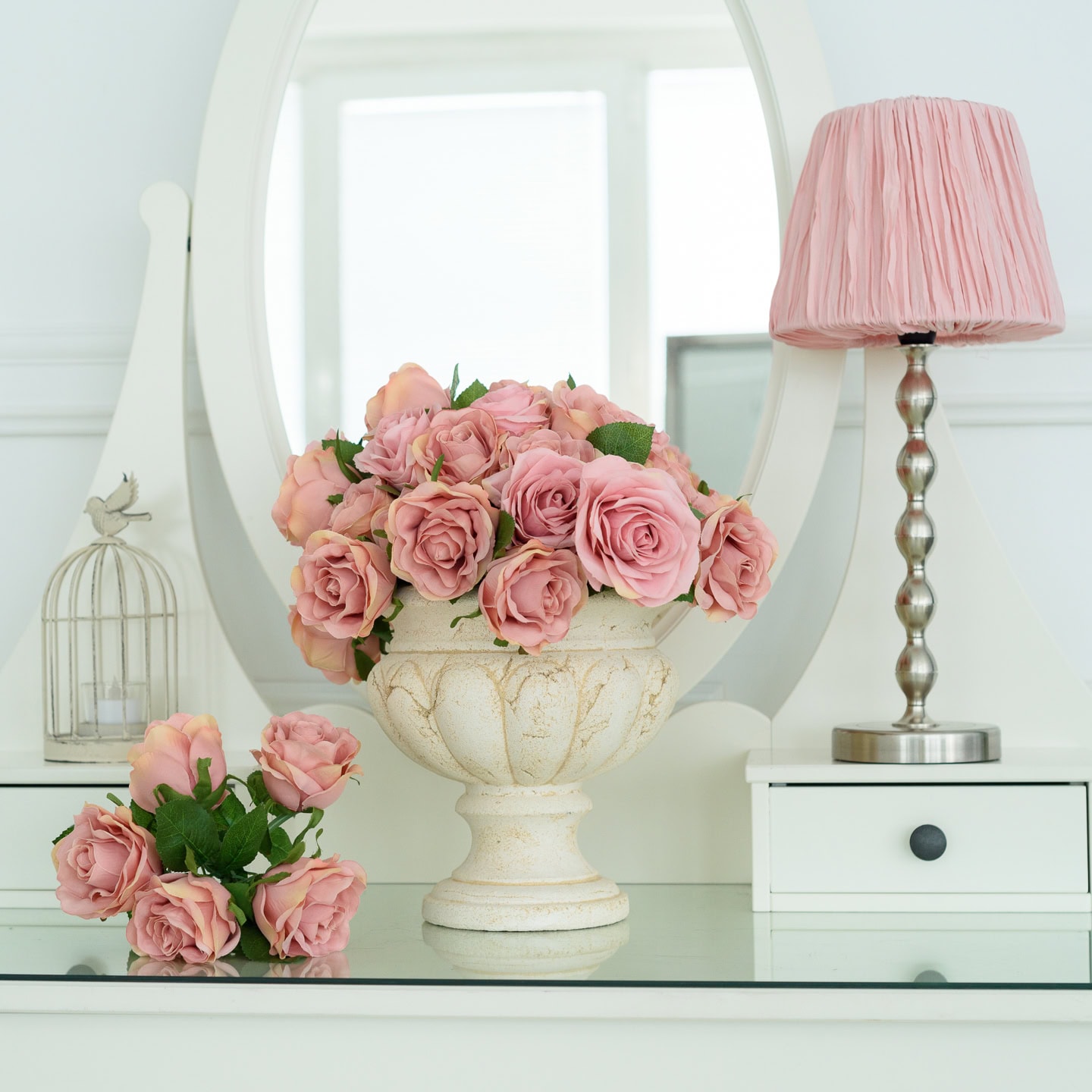 White dresser with pink roses and a pink lamp