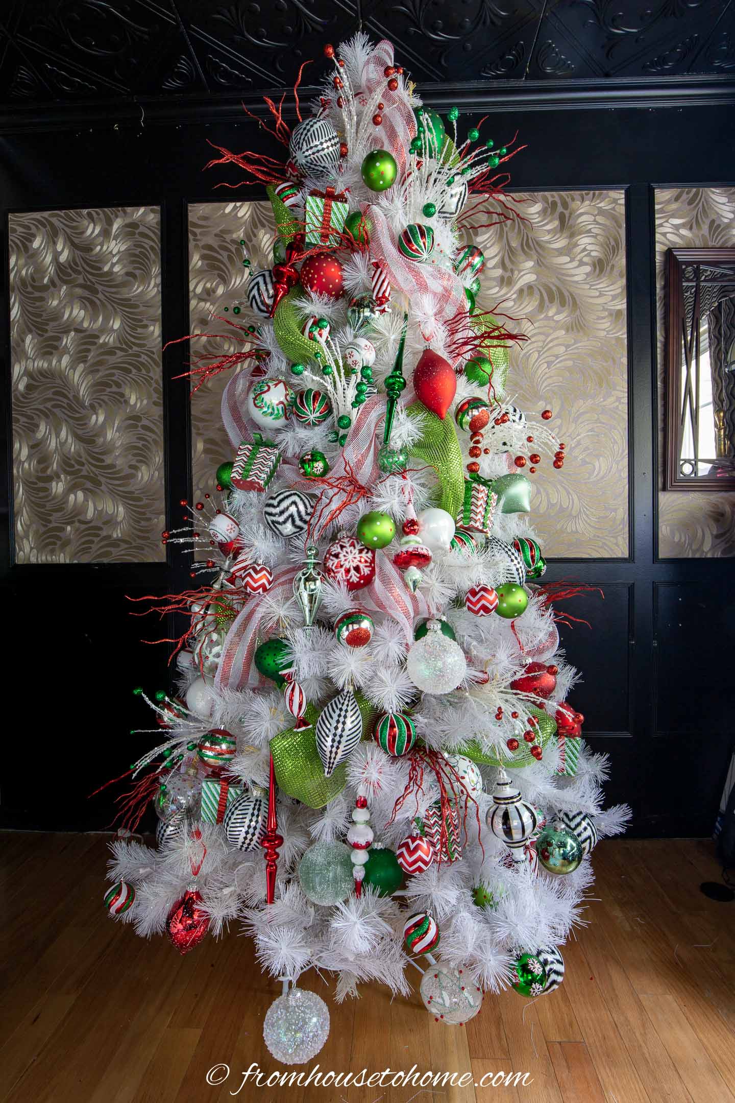White Grinch Christmas tree with ornaments and red picks