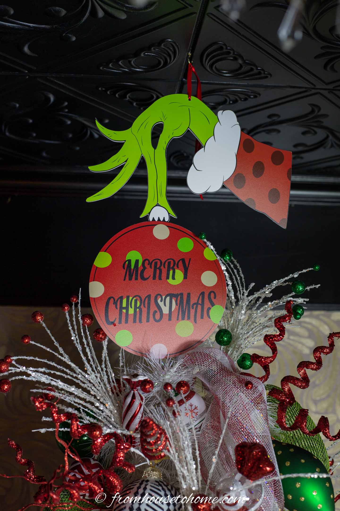 Grinch hand and ornament used as a Grinch Christmas tree topper
