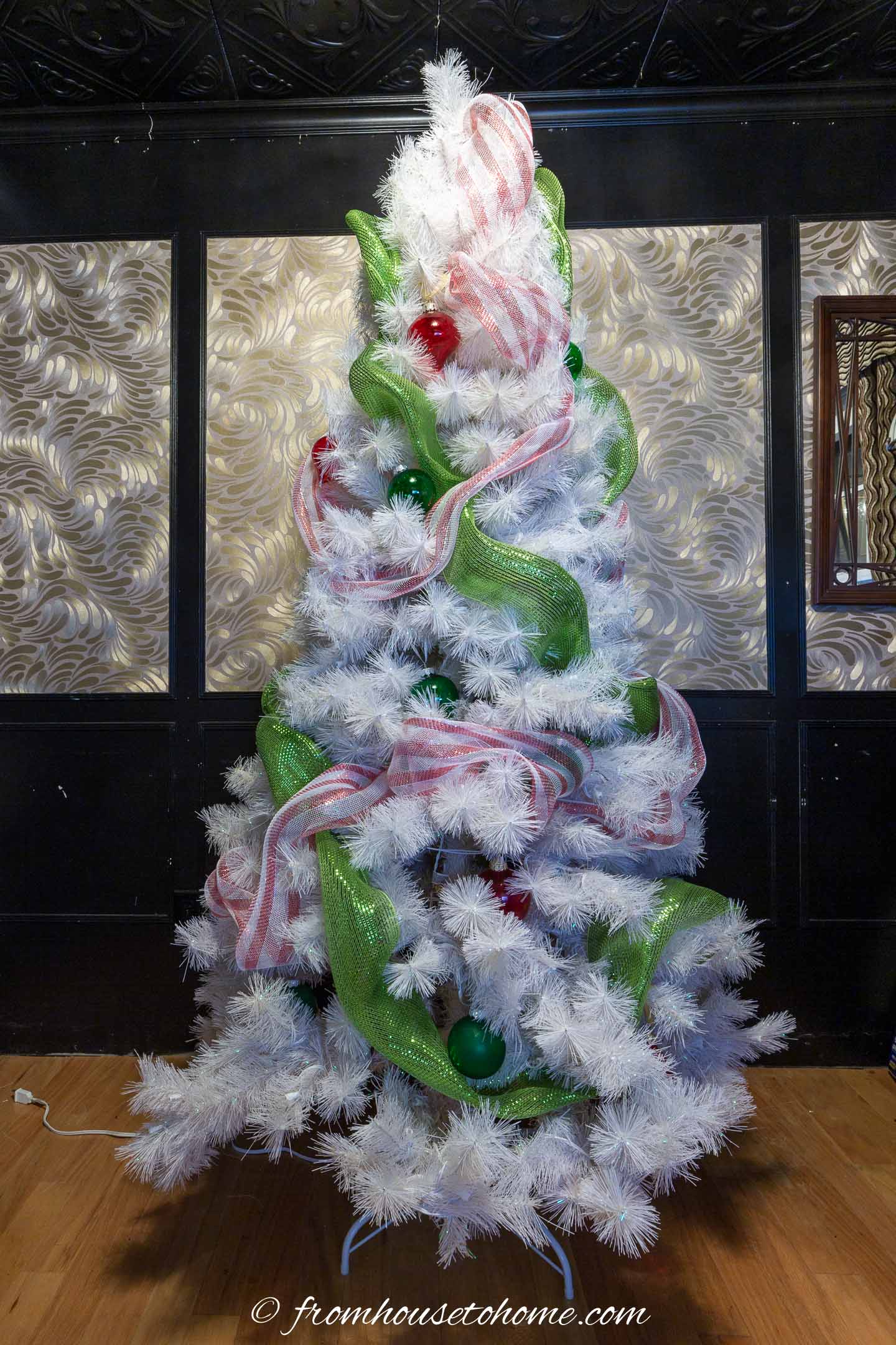White Christmas tree with lime green and red and white deco mesh