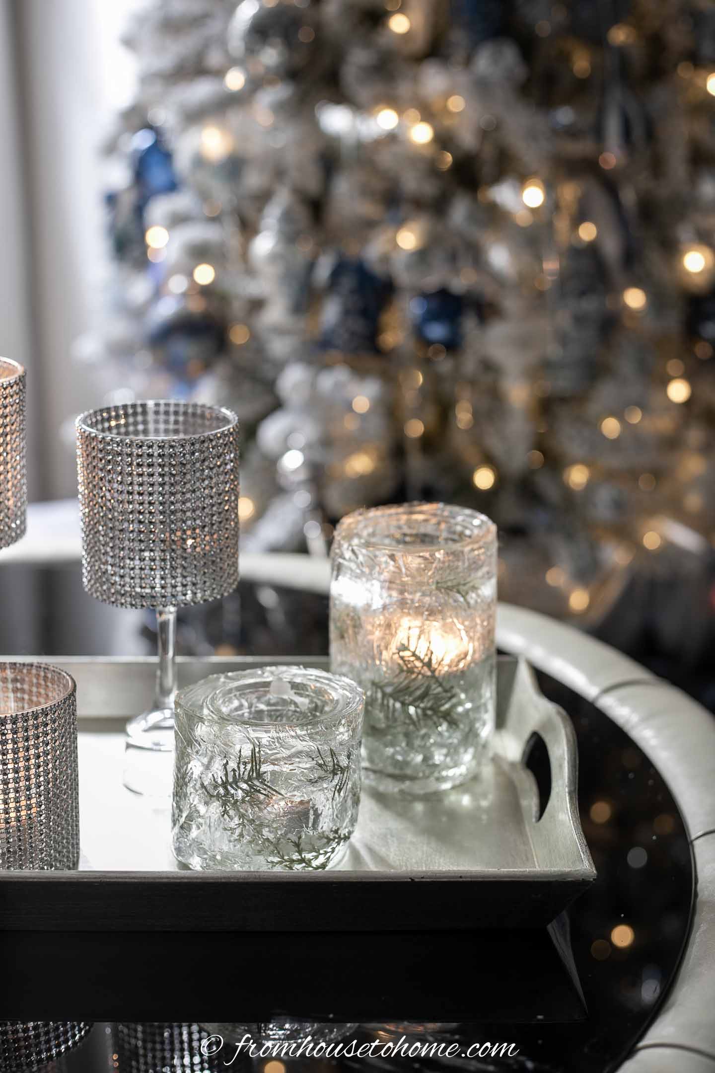 DIY faux ice candle holders in front of a christmas tree