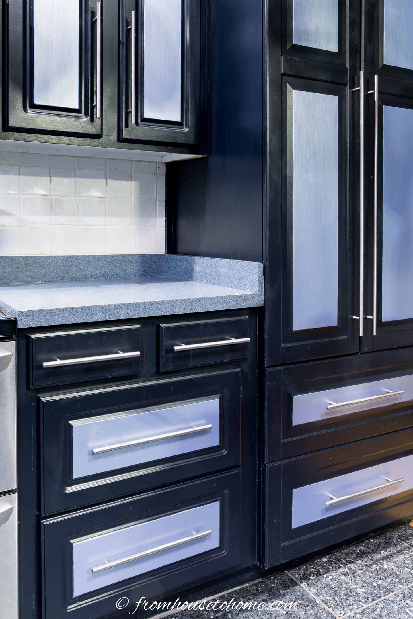 Black kitchen cabinets with silver accents