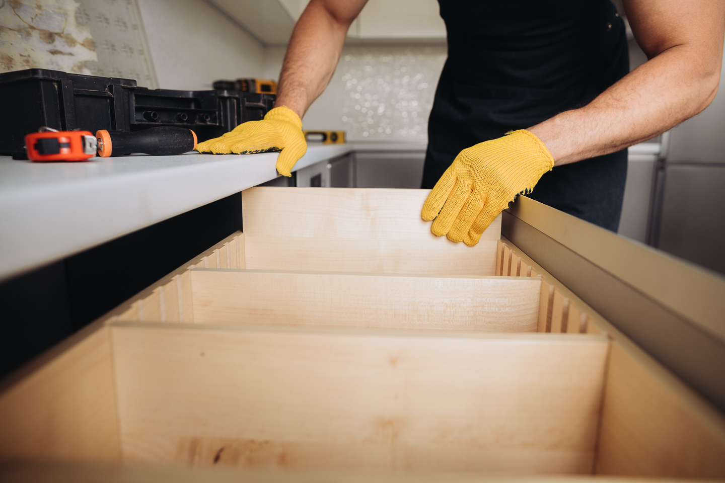 Dividers being installed in a larger kitchen drawer