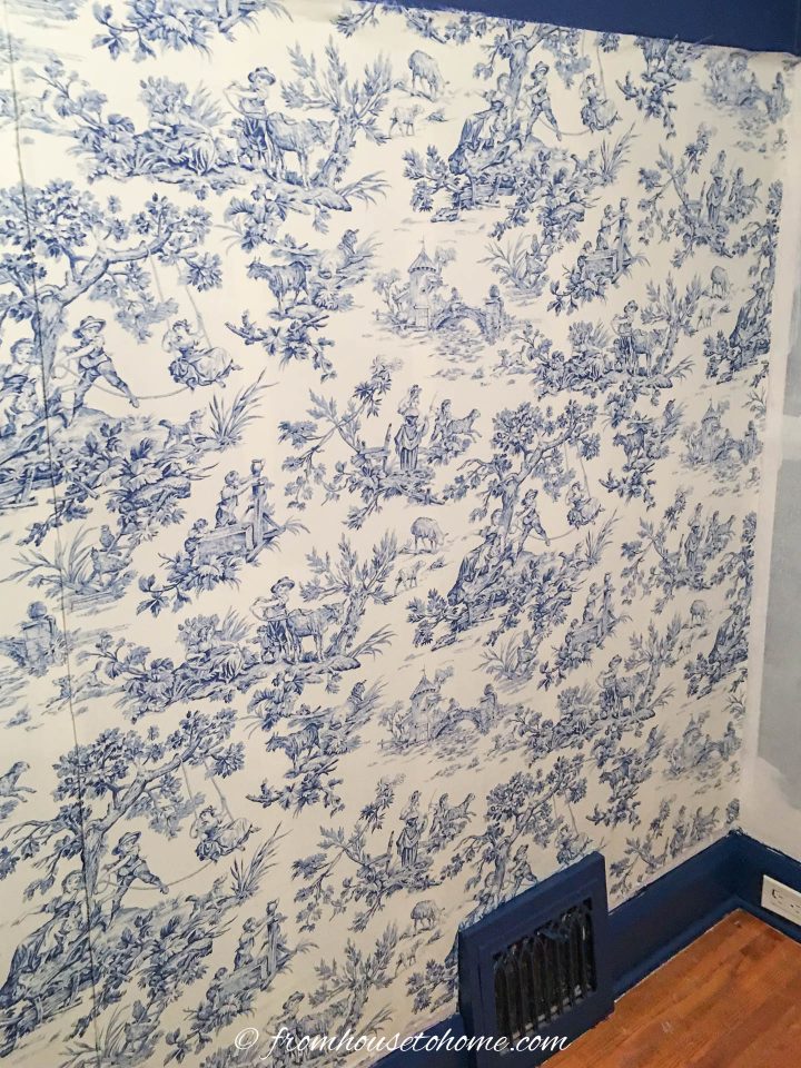 A wall upholstered with blue and white fabric