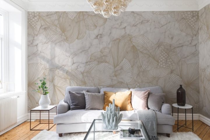 Marble patterned wallpaper on an accent wall behind a gray couch