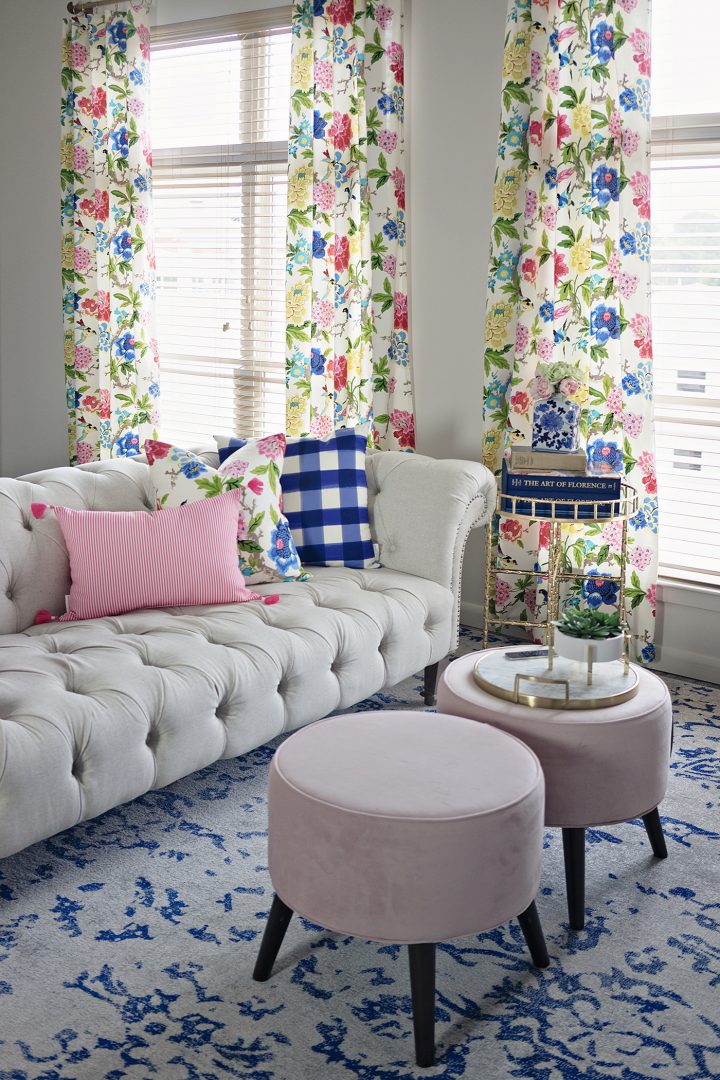 Large living room windows with floral curtains
