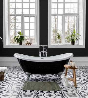 bathroom with black clawfoot tub and black and white floor tiles