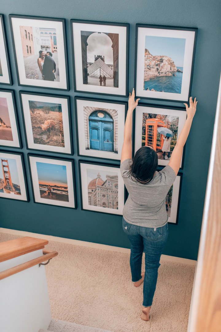 A floor to ceiling gallery wall with travel inspired photos.  