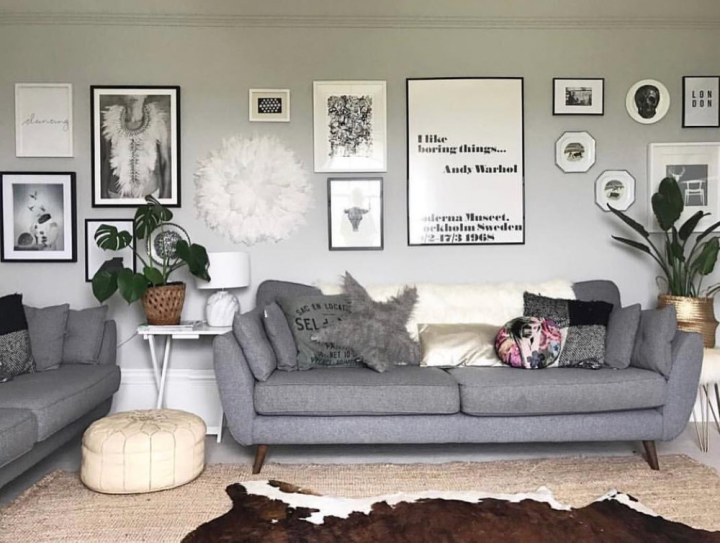 A living room featuring a monochromatic art wall. 
