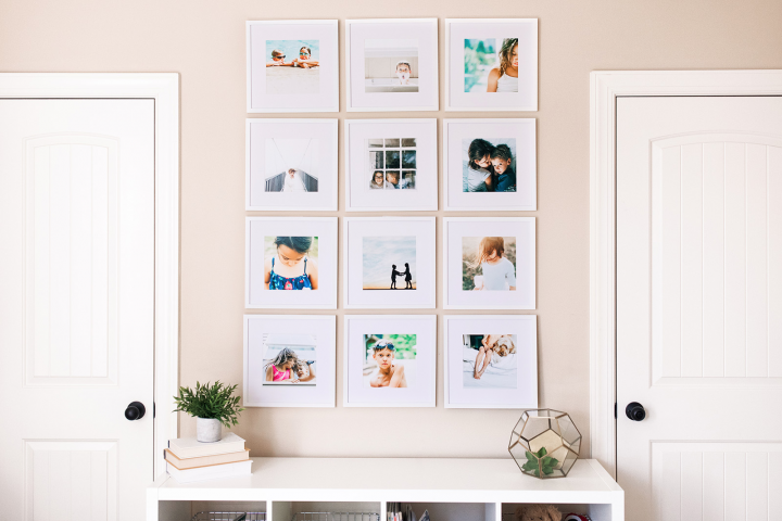 Several small, square framed featuring instagram photos hung on a neutral colored wall. 