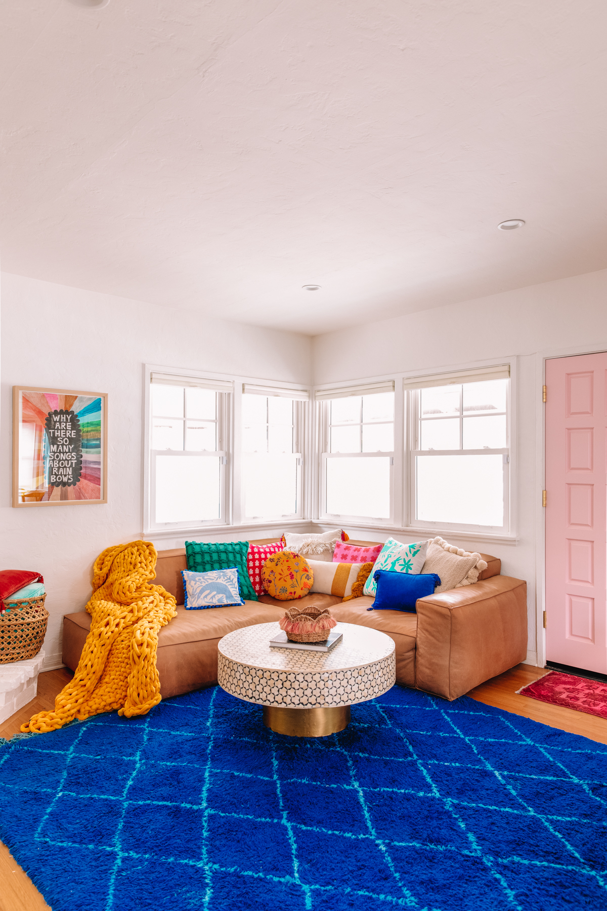 An L-shaped sectional sofa in the corner of a brightly colored living room.