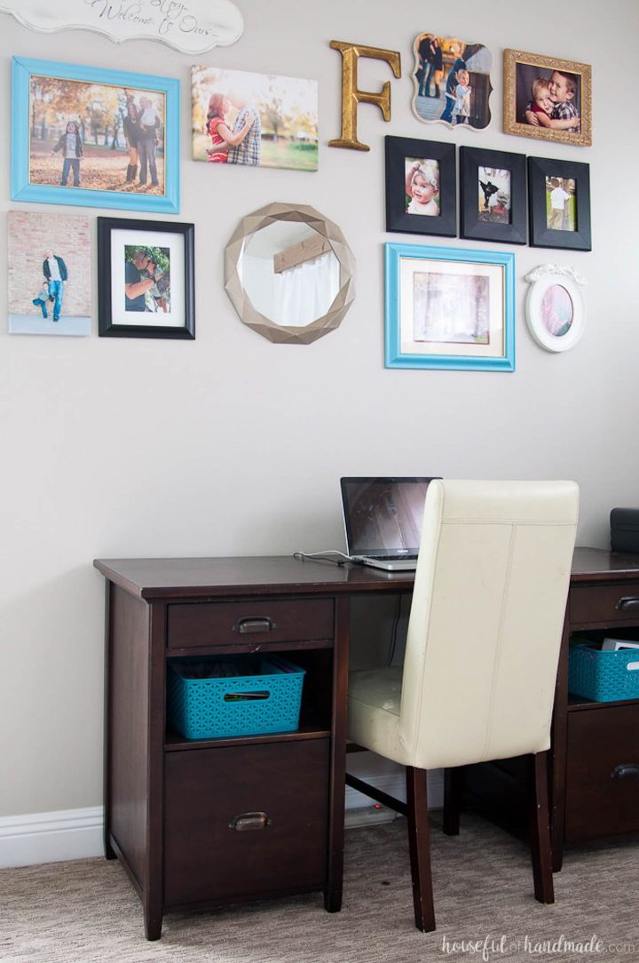 Desk in front of a photo gallery on a wall painted with Sherwin Williams Agreeable Gray (©housefulofhandmade.com)