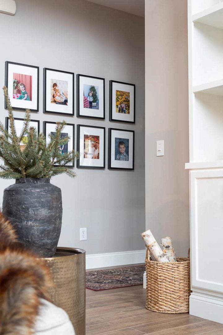 A hallway with a photo gallery and walls painted in Sherwin Williams Collonade Grey