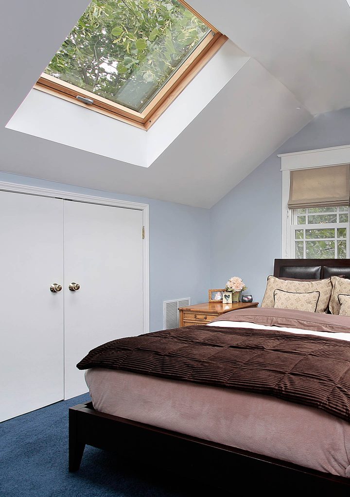 Attic bedroom with a large skylight