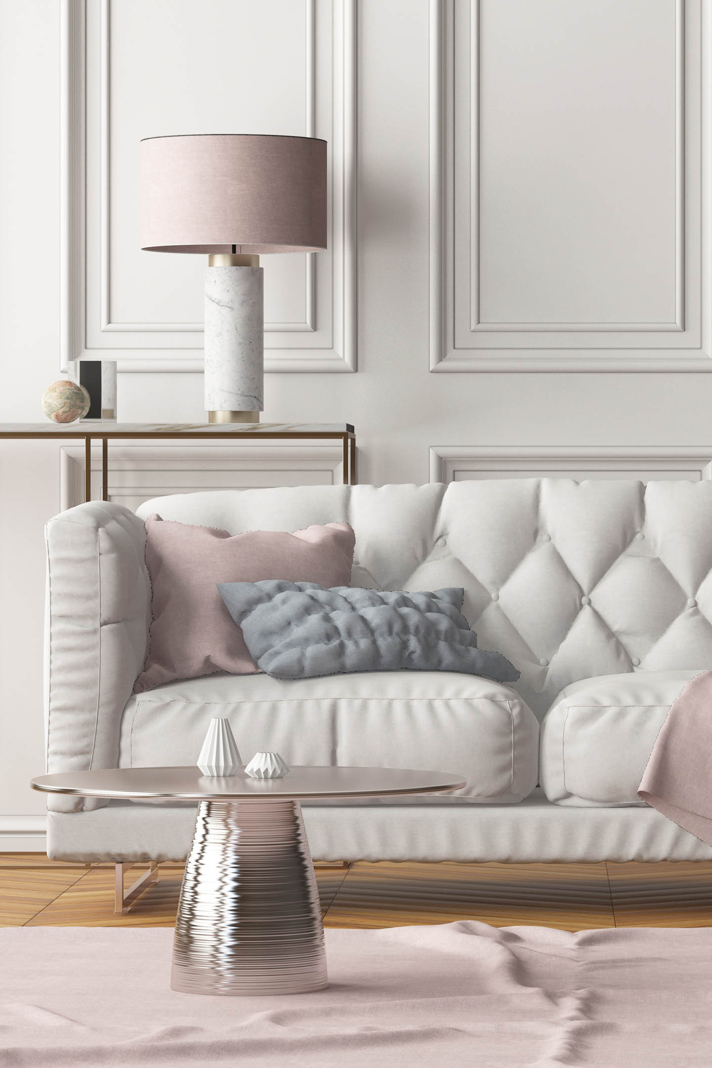 Round rose gold coffee table in front of a greige colored sofa with pink cushions