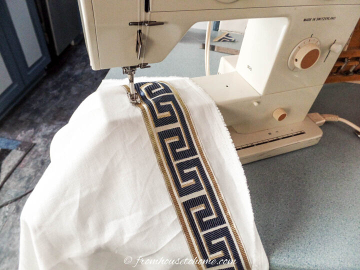 Sewing trim on the edge of a curtain