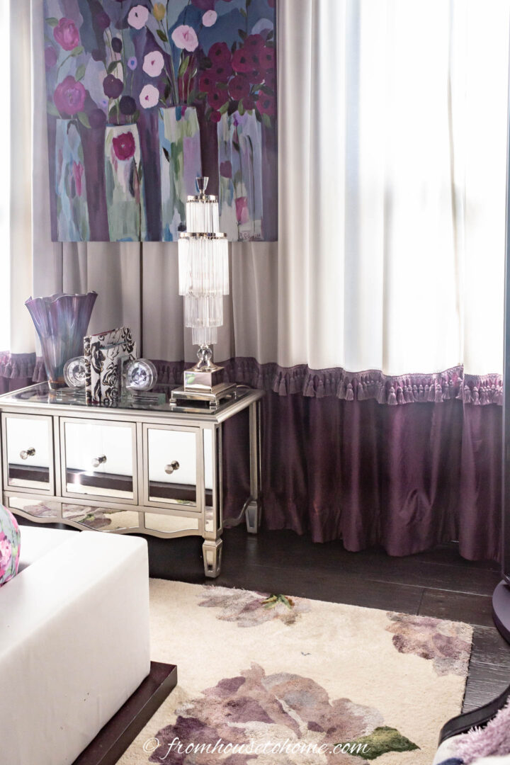 White curtain with purple tassel trim and band of fabric at the bottom