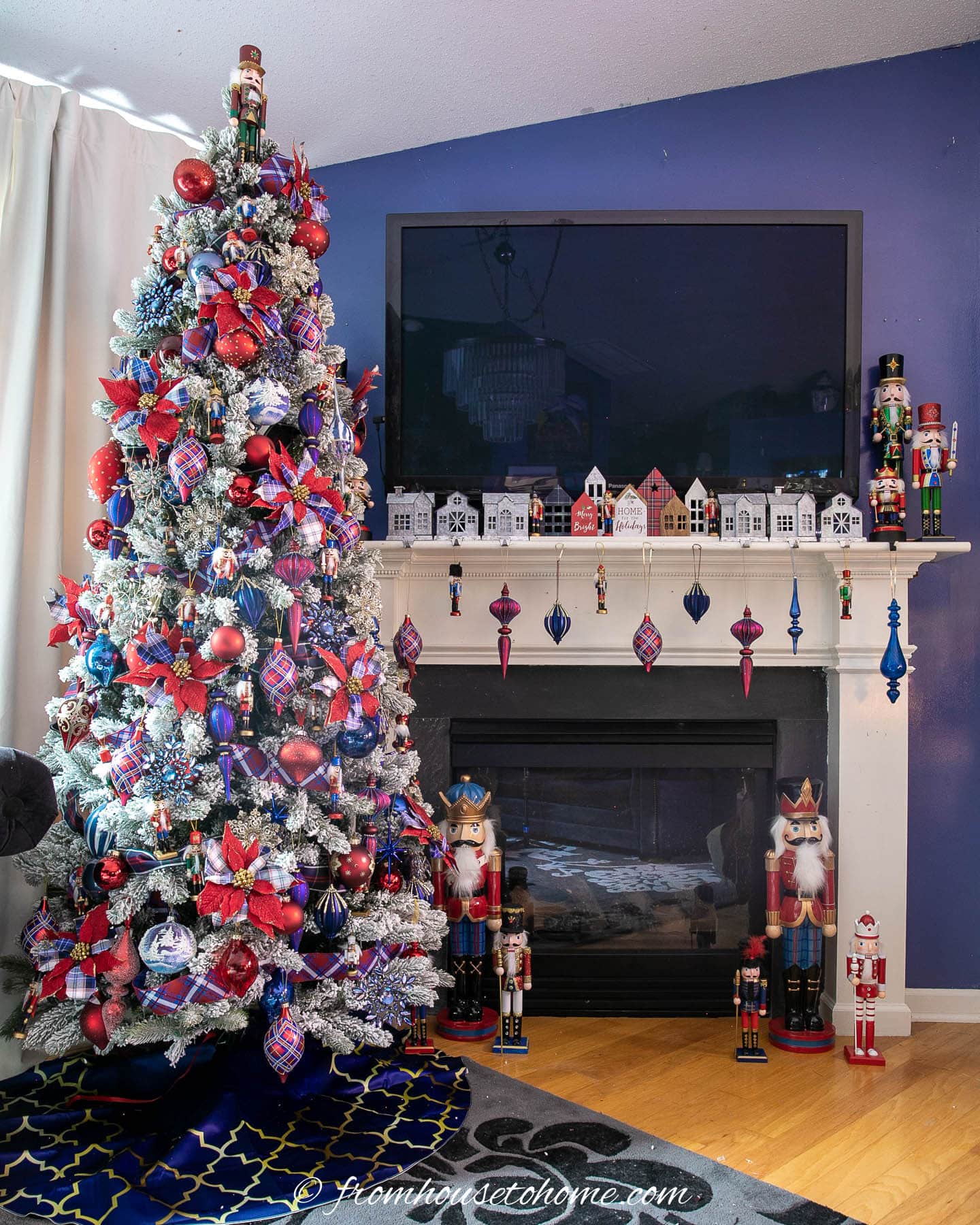 Nutcracker Christmas tree beside a fireplace decorated with red and blue ornaments and nutcrackers