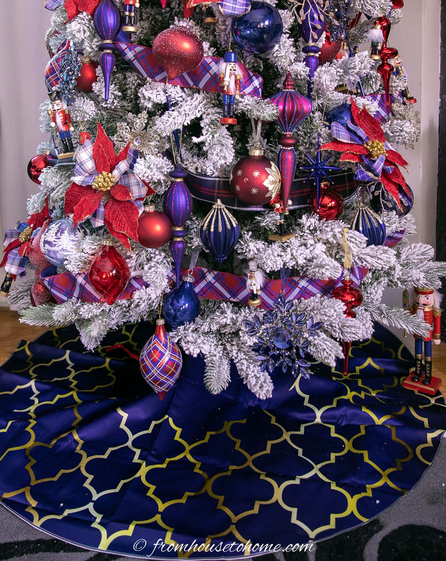 Blue and gold tree skirt under a nutcracker Christmas tree