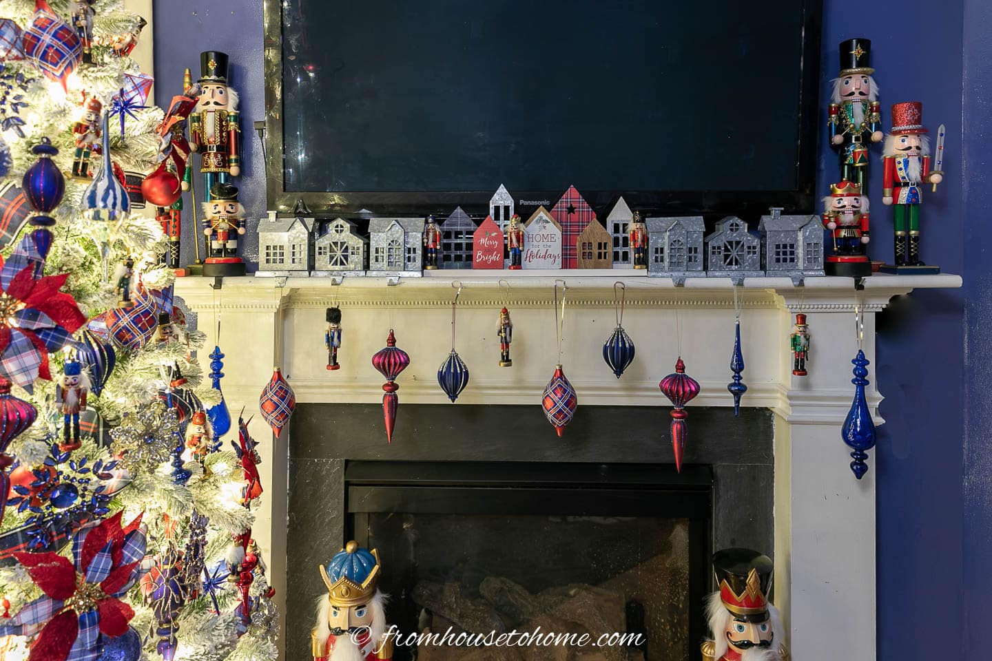 Fireplace mantel decorated with nutcrackers and red and blue ornaments