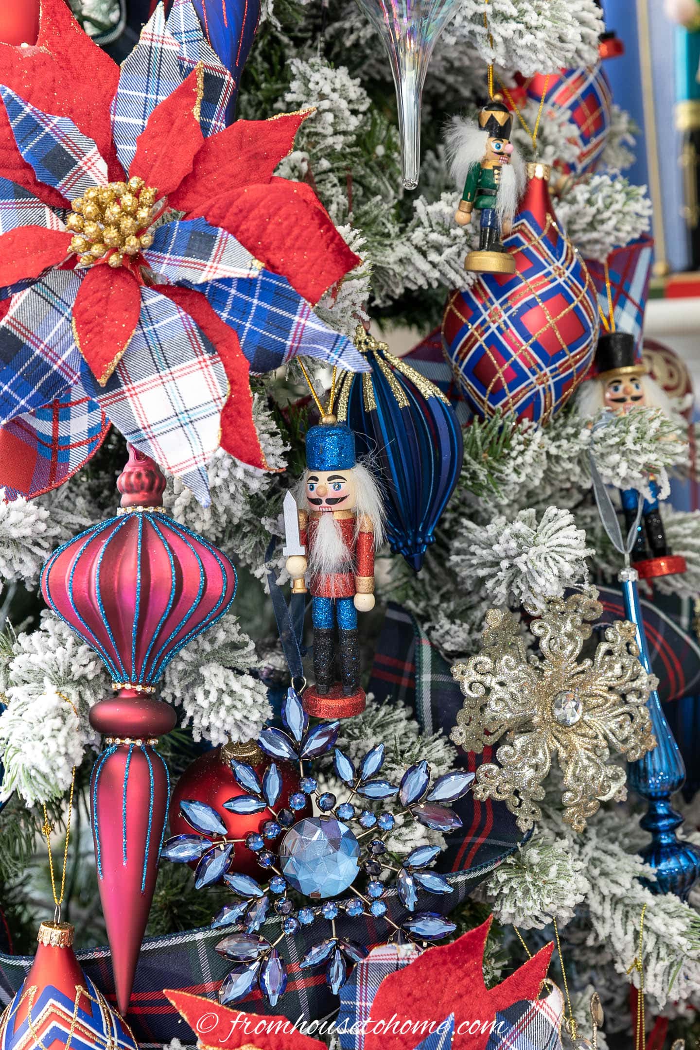 Nutcracker ornaments hung on a Christmas tree with red and blue ornaments