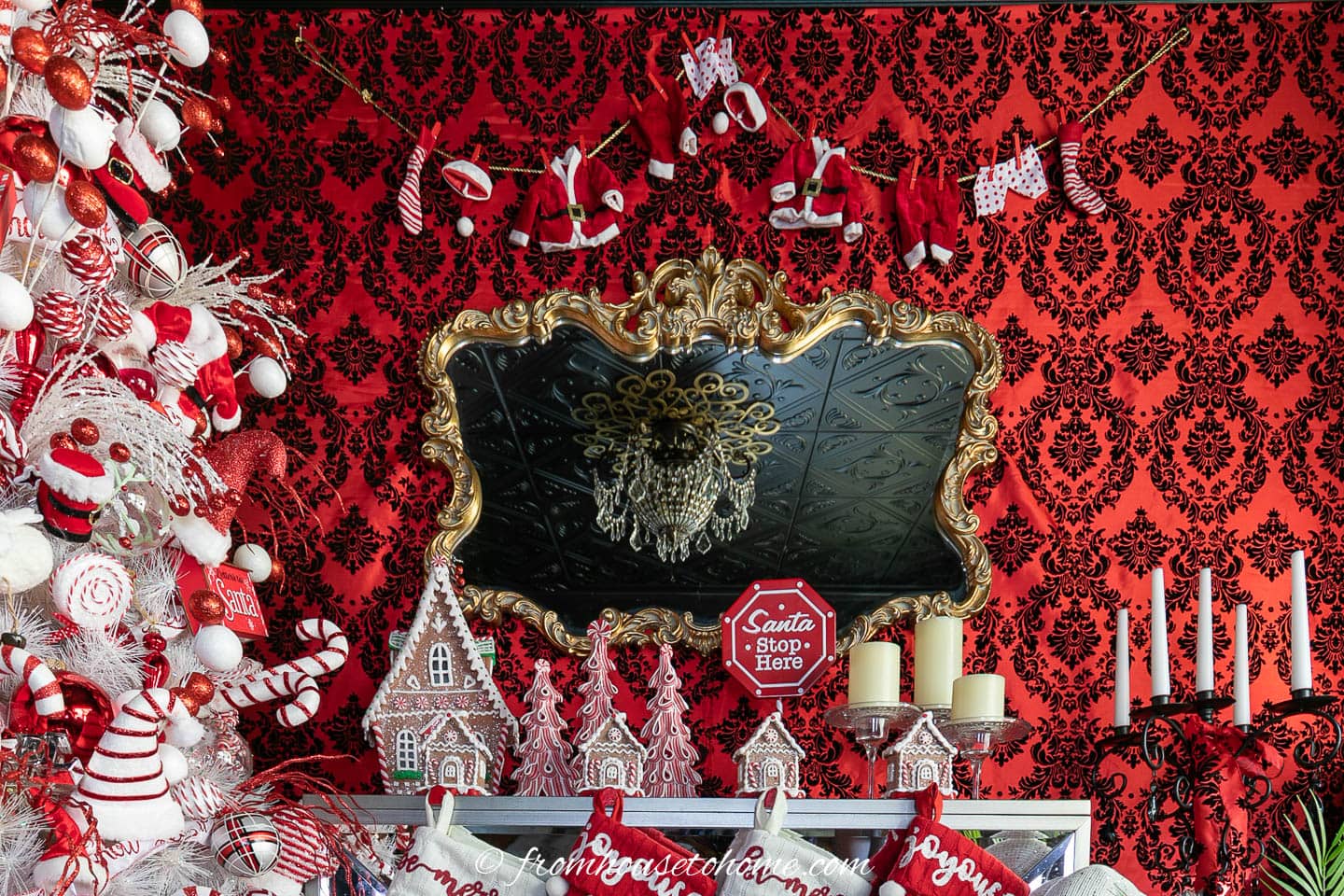 Santa clothesline garland hung above the fireplace mantel beside the Santa Christmas tree
