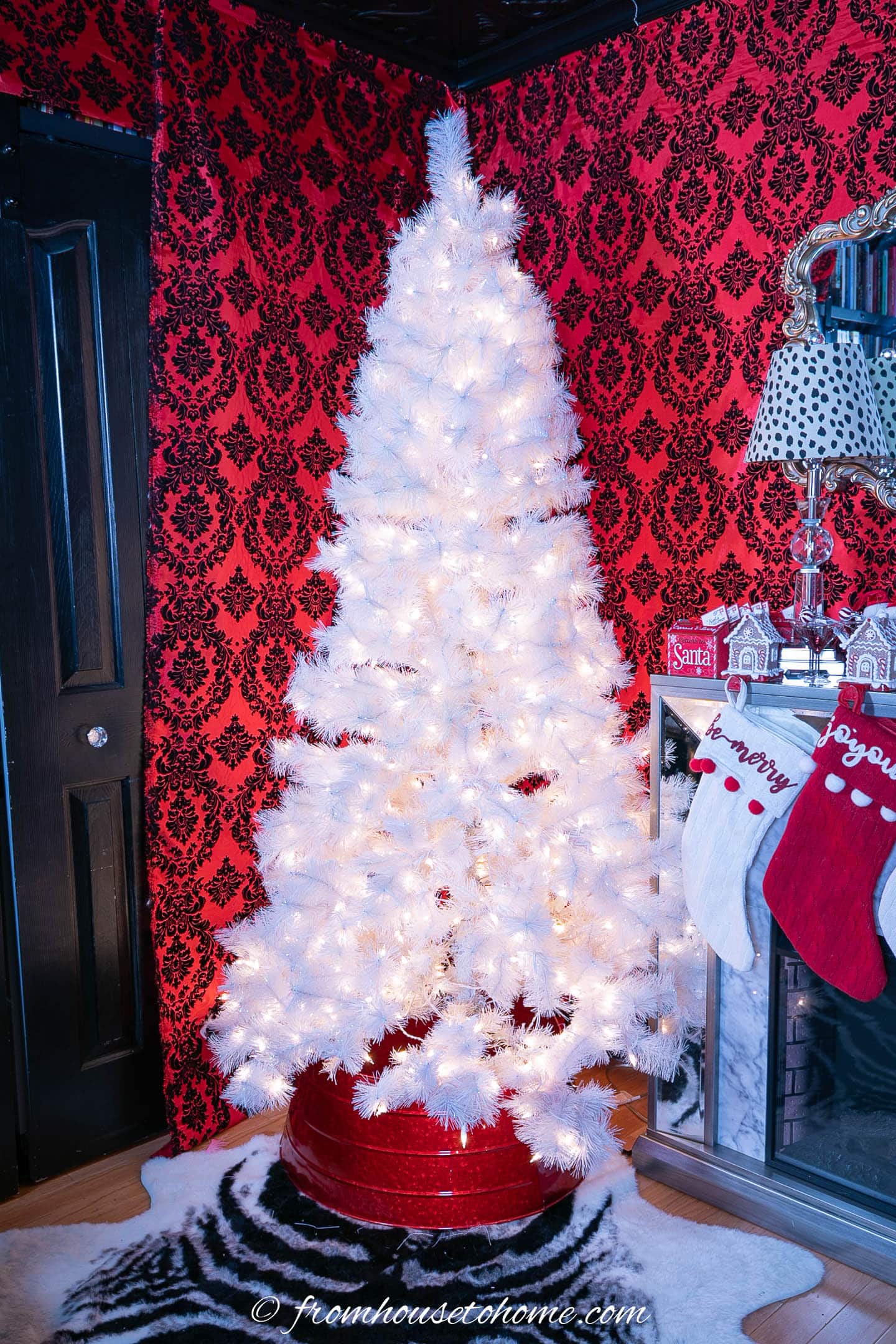 White Christmas tree with a red tree collar