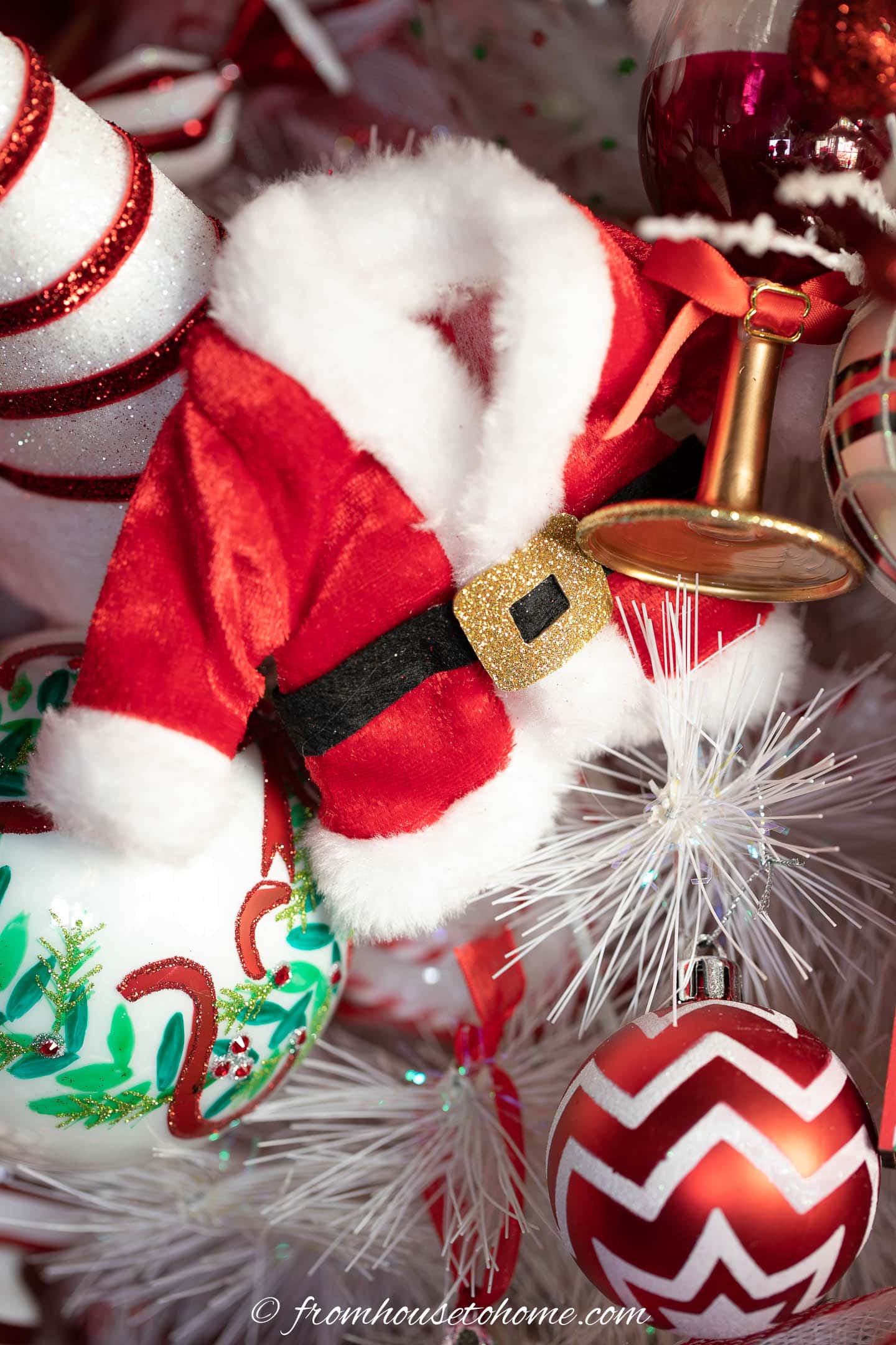 santa coat ornament on a white Christmas tree