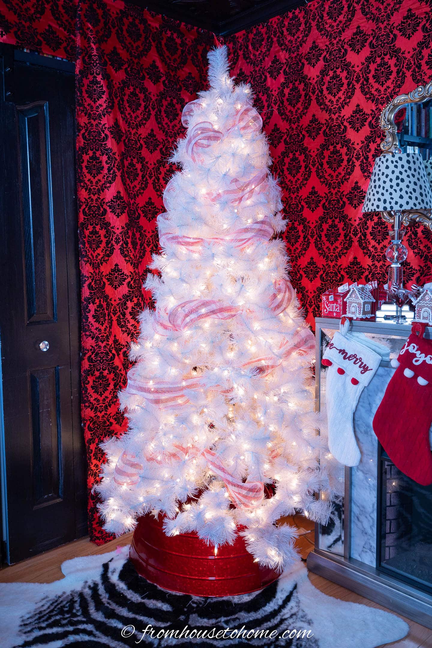 White Christmas tree wrapped with red and white striped deco mesh