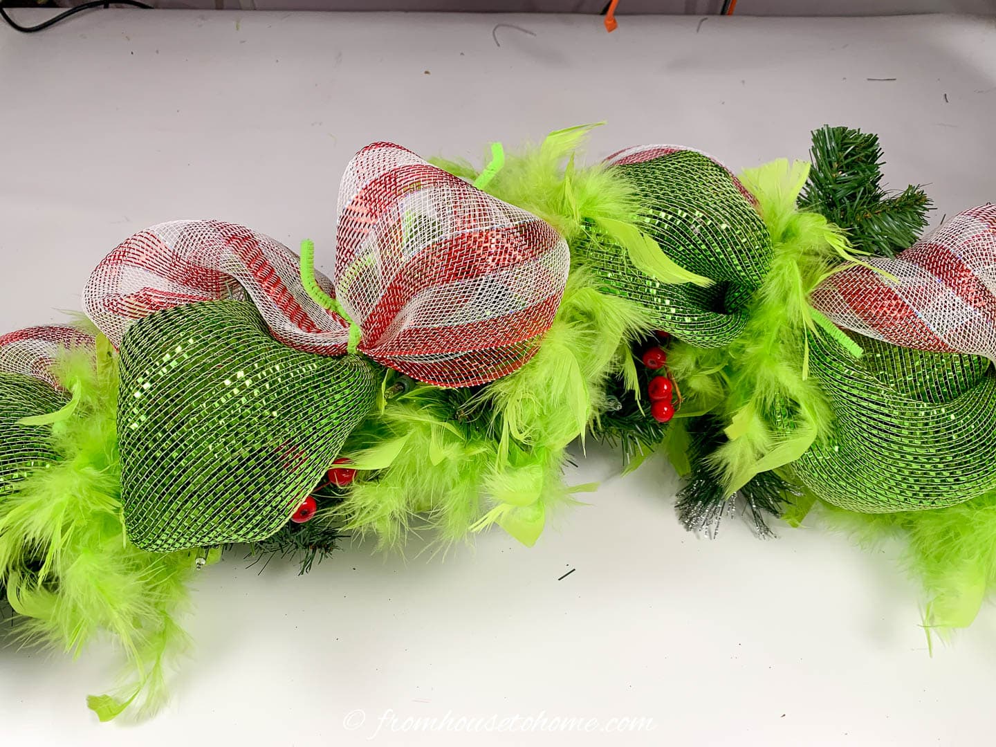 How to add lime green feather boas to the Grinch garland
