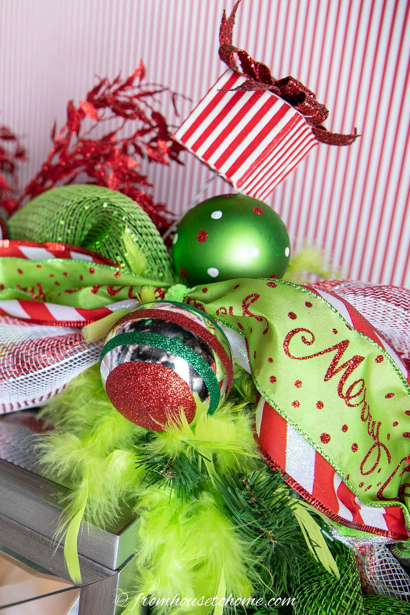 Close up of the ornaments and picks in the Grinch Christmas mantel garland