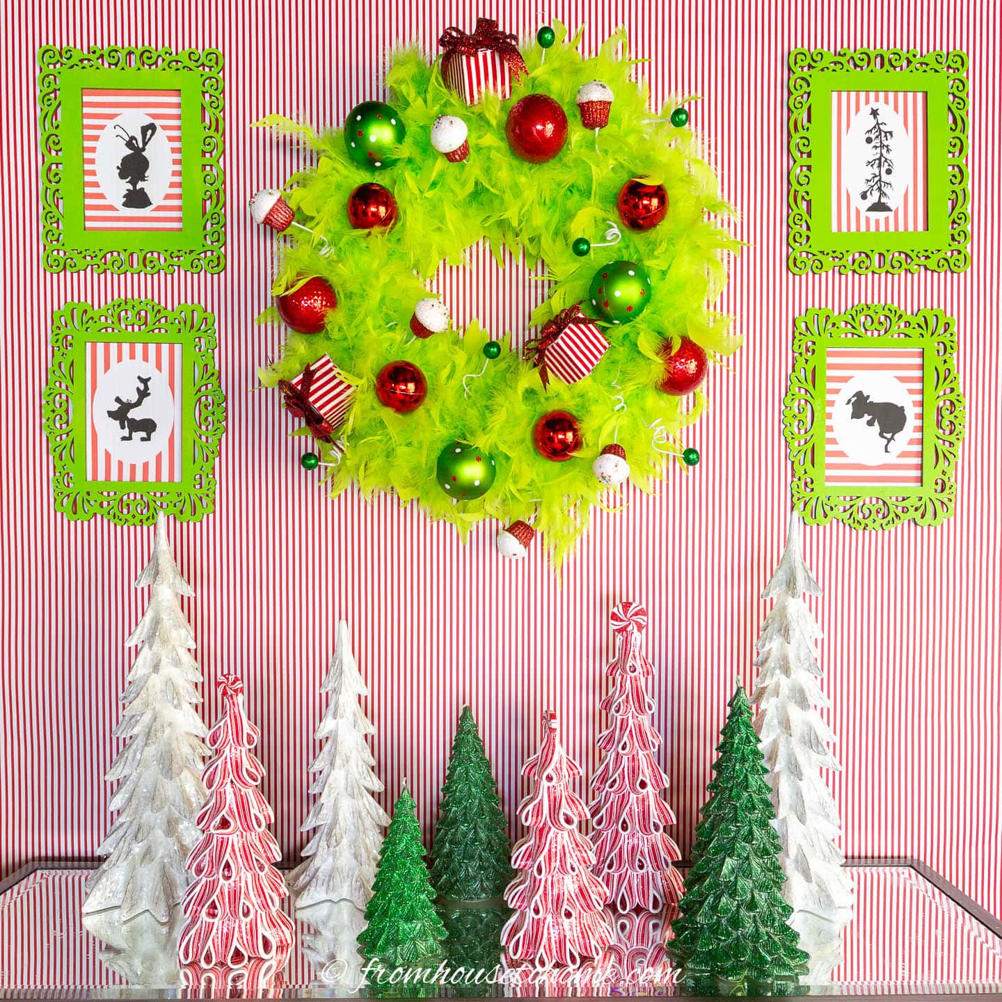 printable Grinch pictures on either side of a wreath above the fireplace