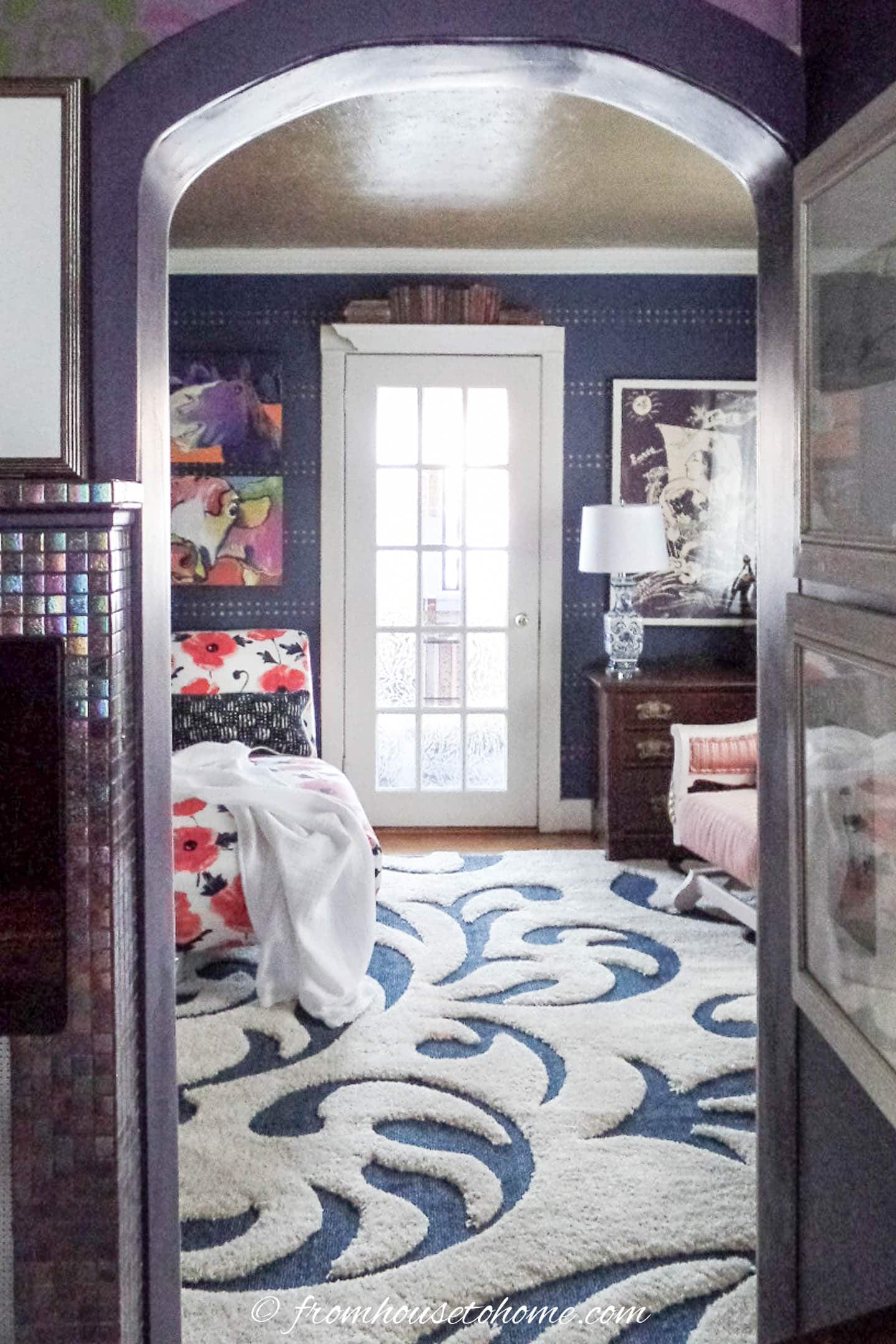 A view of the blue and white living room from the doorway