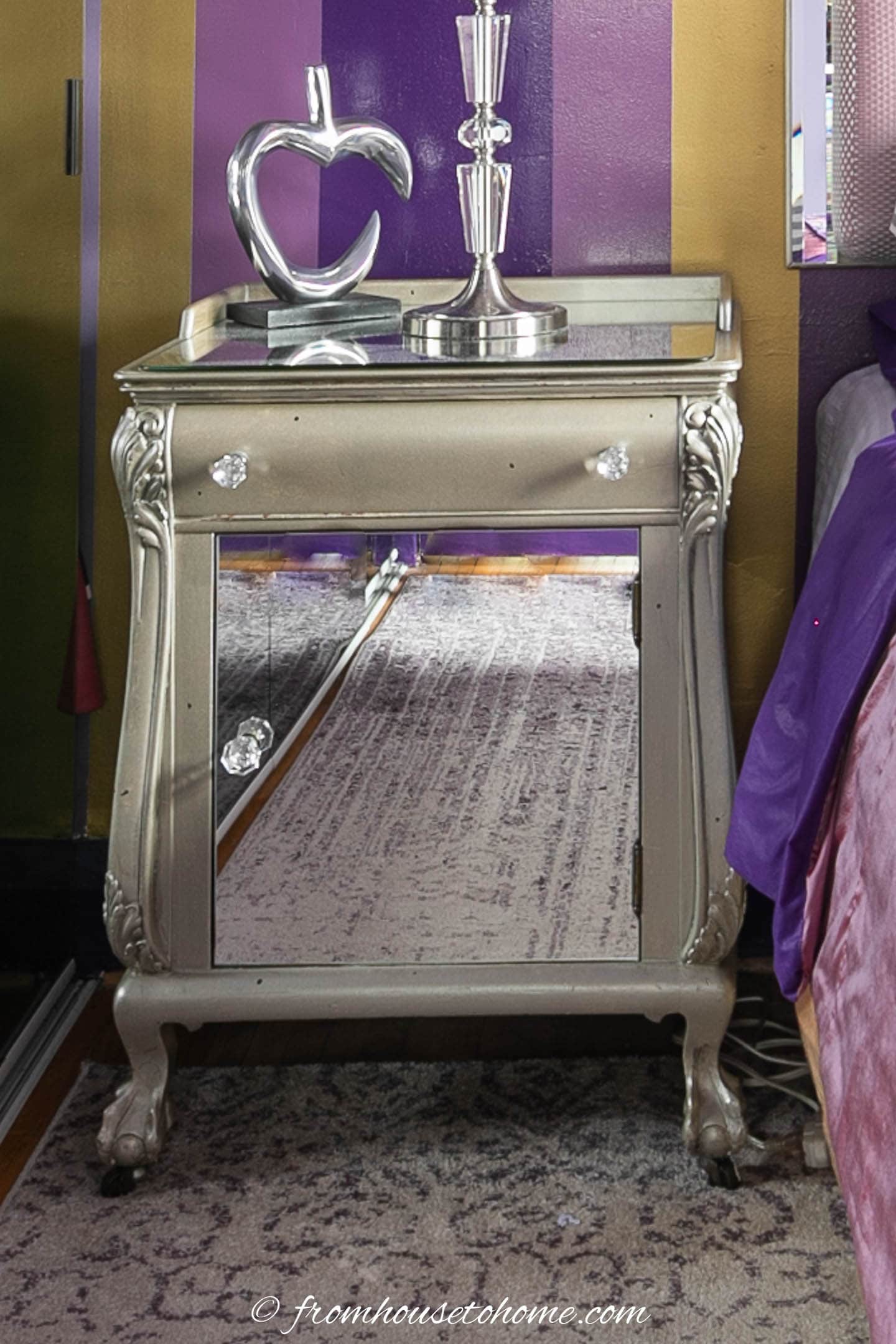 upcycled nightstand painted silver with a mirror door and top, and crystal knobs
