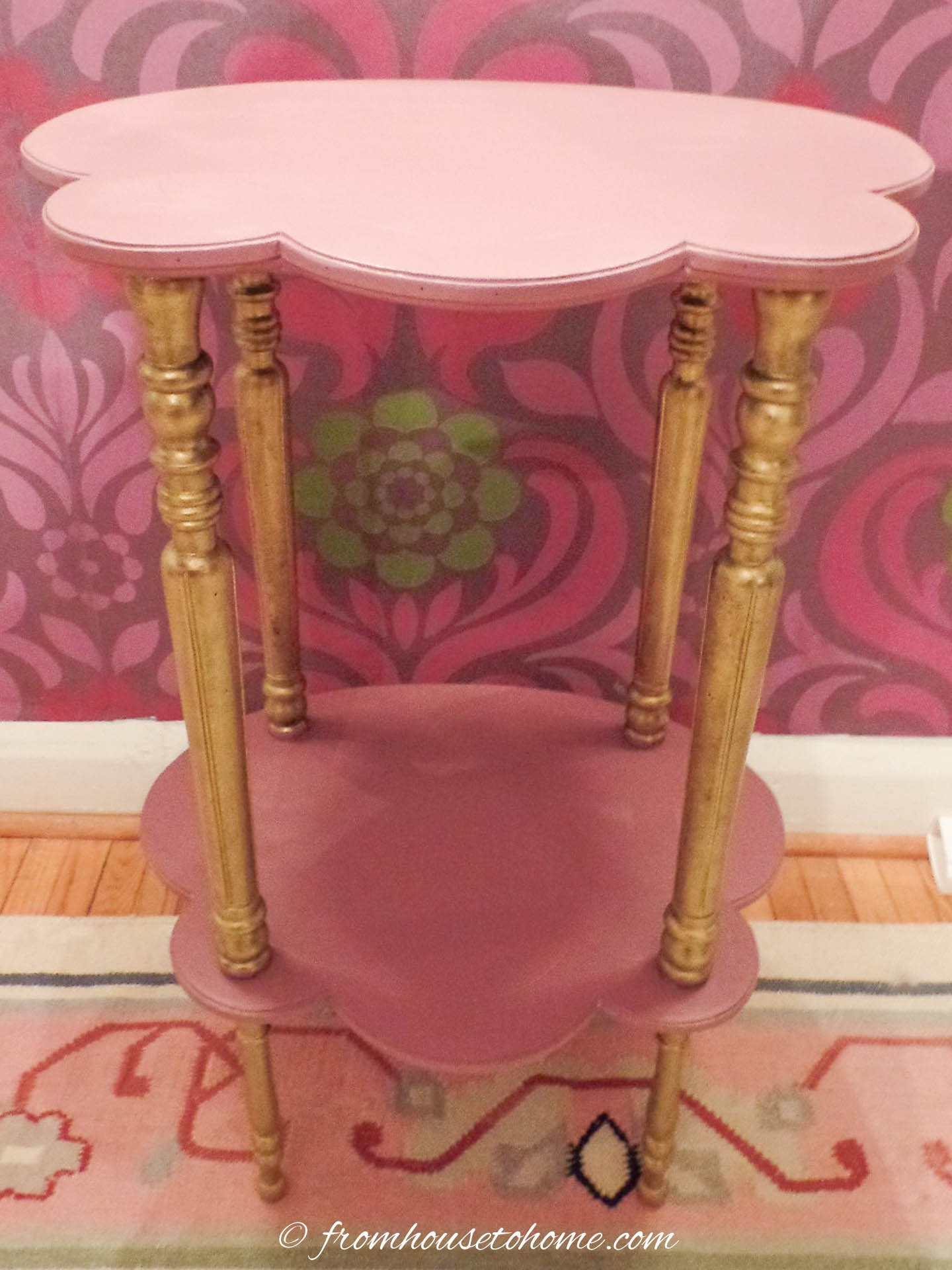 The tiered table with the top painted pink and the legs covered with gold wax