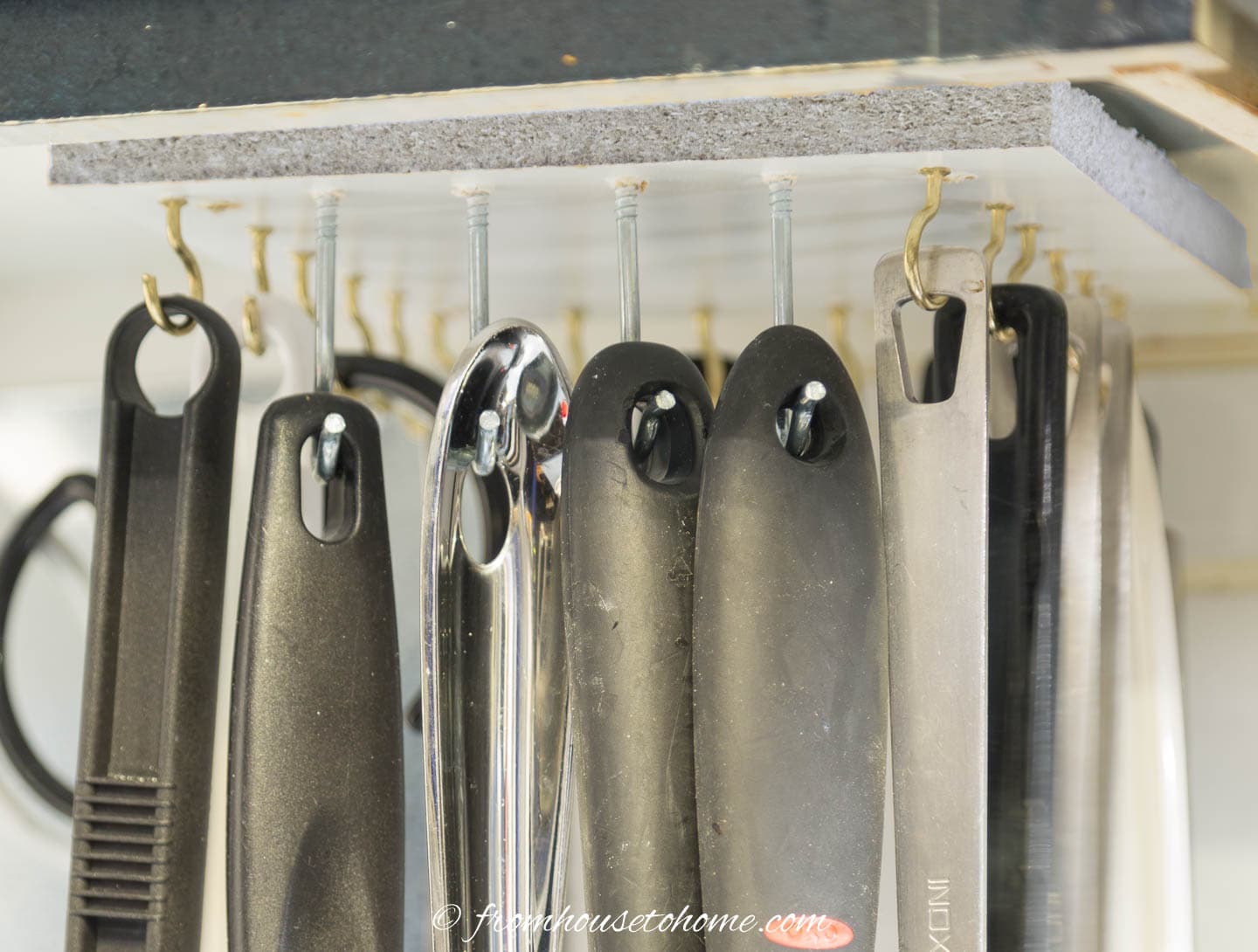 Close up of hooks on the DIY under cabinet storage rack