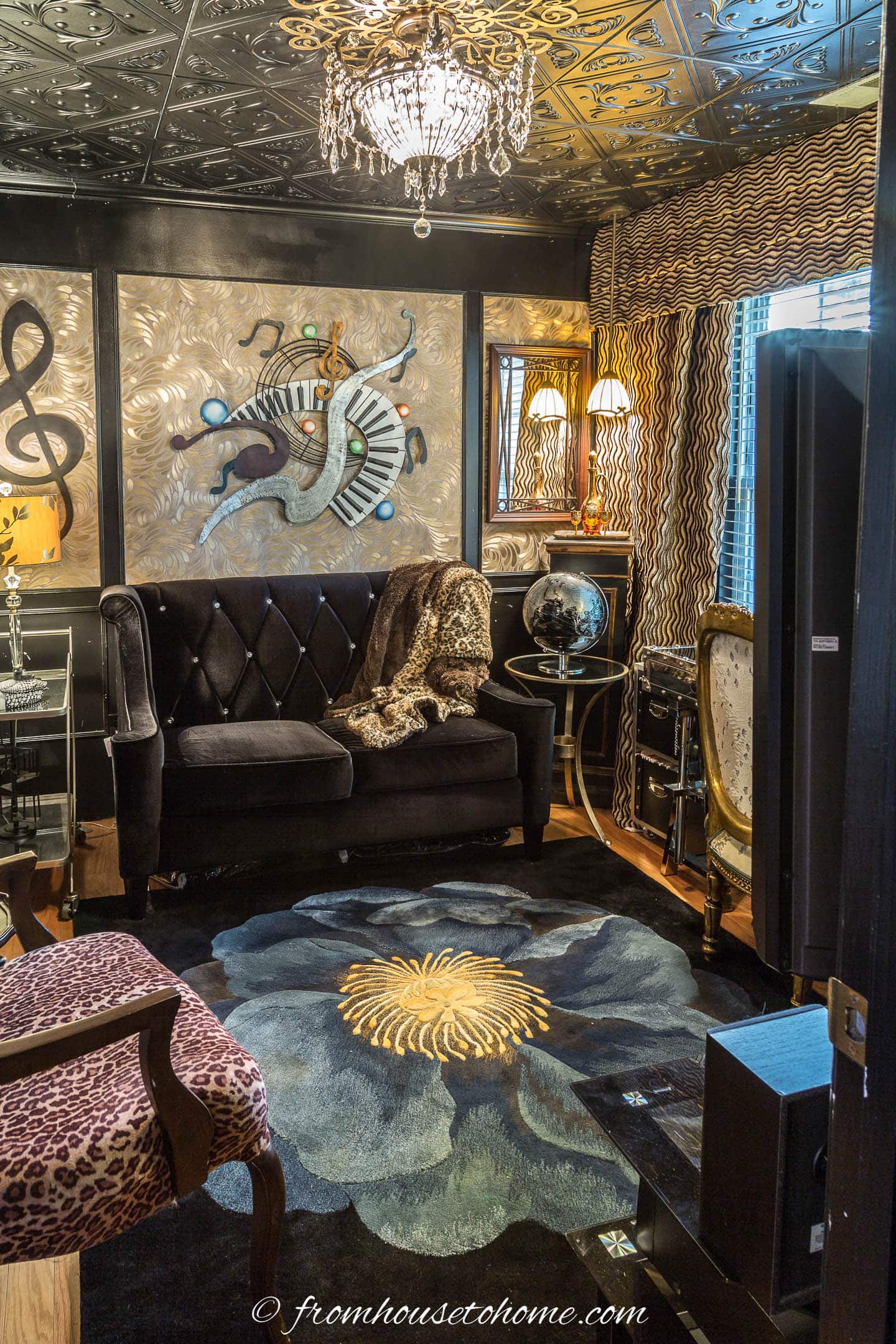 Den with black walls and ceiling as well as gold wall-paper inserts